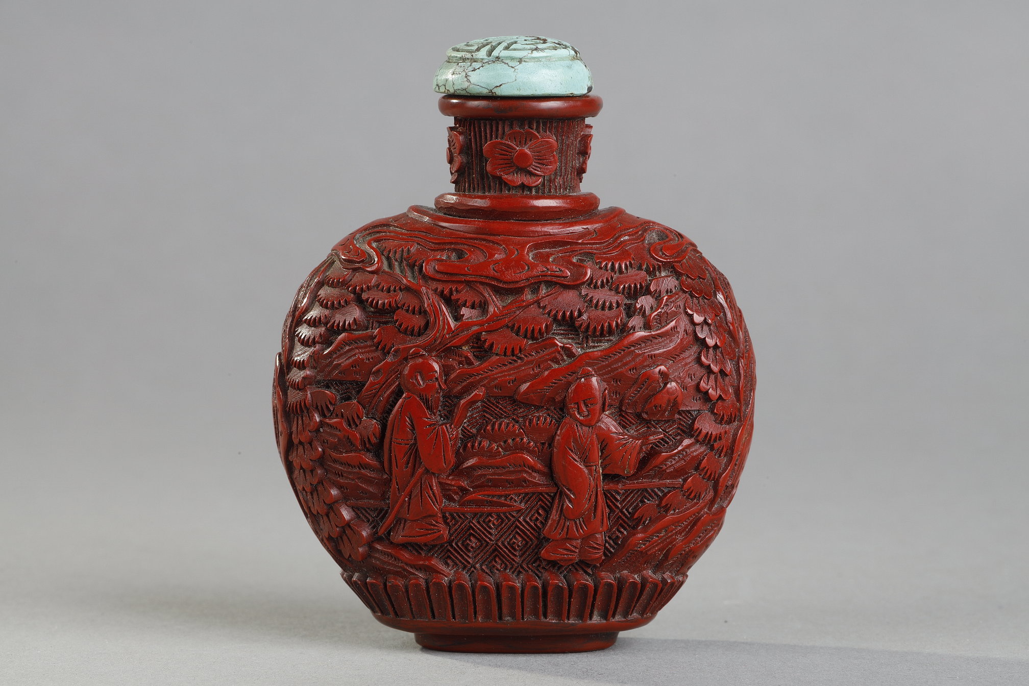 Snuff Bottles : Cinnabar red lacquer snuffbottle decorated with scholars under the pines . the sides decorated with rocks - China 19th century
