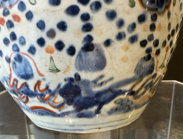Blue White : Porcelain bottle vase enameled in green cobalt blue and red iron decorated with lambrequins and pendants embellished with flowers, at the bottom of the galloping horses H 22cm China, period Wanli, late 16th century