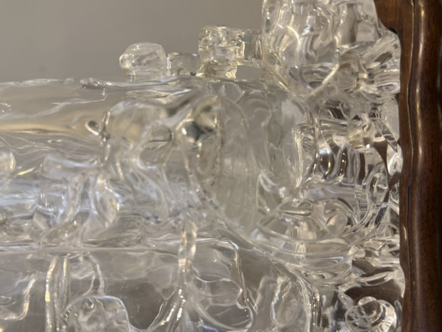 Works of Art : Rock crystal vase of bamboo double trunk form ,the sides carved in relief with pines and a bird perched on the branch facing a deer ,and a tree with grenades adorned with a phenix standing on a rock base facing a qilong at the top of the vase 
China 19th century    H 19cm
with wood stand
